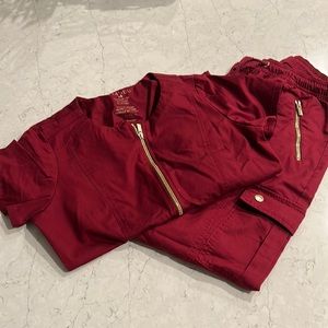XS Jaanuu burgundy with gold buttons and zippers scrub set. Good condition worn